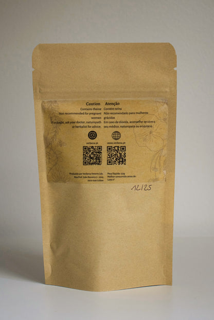 Kraft paper packaging of 'Midnight Sun' tea blend with visible ingredients on a plain background