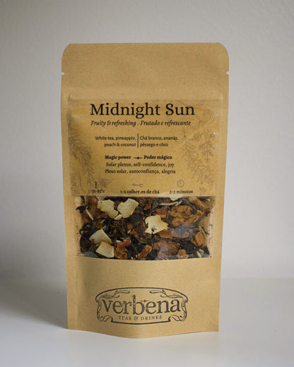 Kraft paper packaging of 'Midnight Sun' tea blend with visible ingredients on a plain background