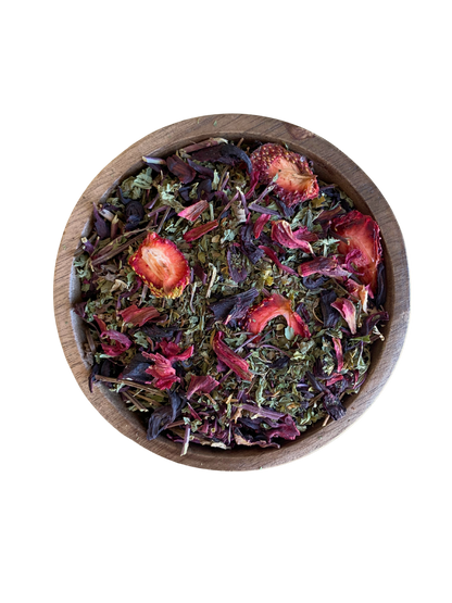 Wooden bowl filled with colorful dried herbs such spearmint, strawberries and hibiscus.