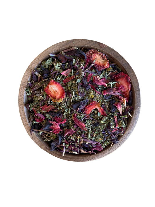 Wooden bowl filled with colorful dried herbs such spearmint, strawberries and hibiscus.