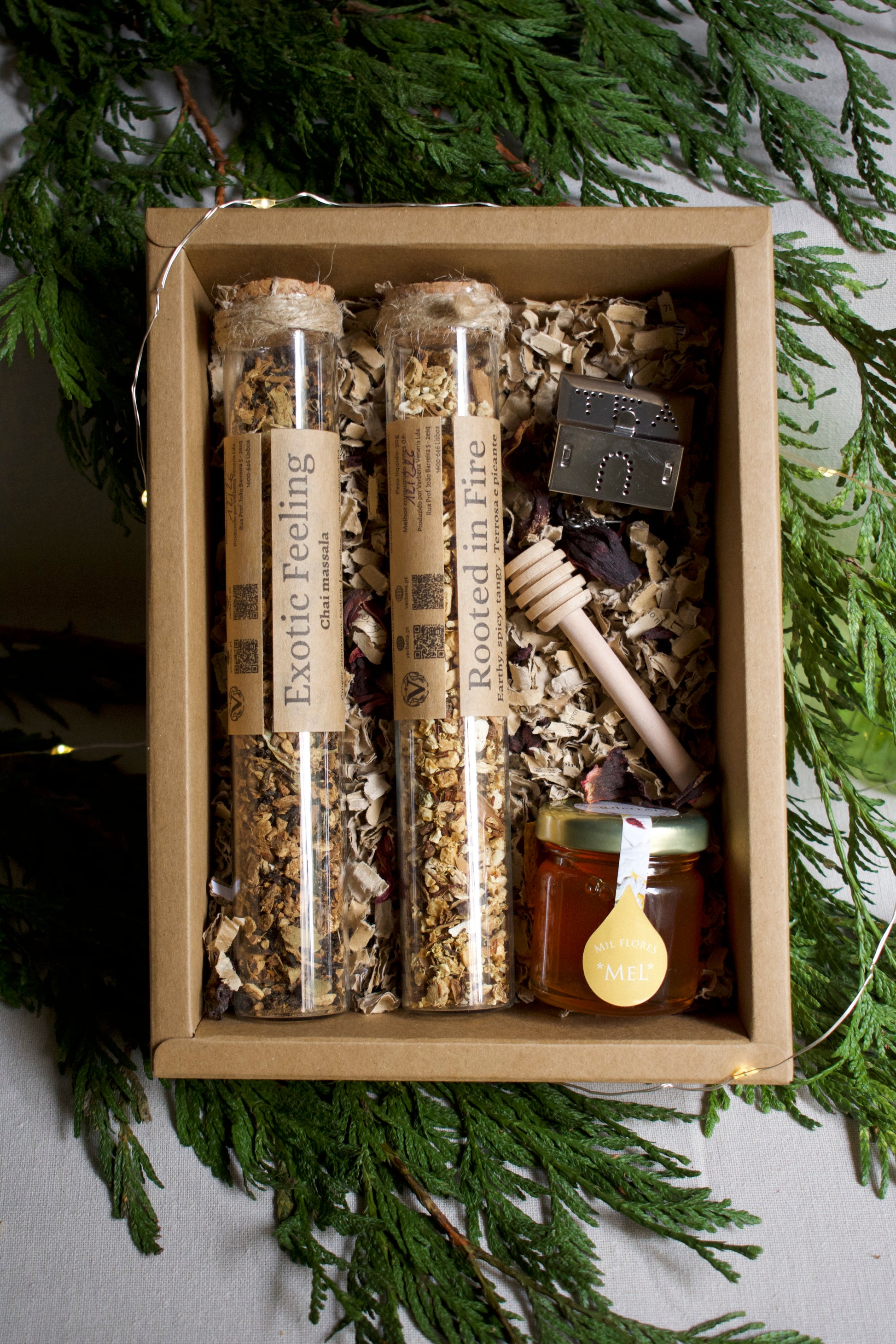 Box of natural products including honey and herbs with greenery in the background