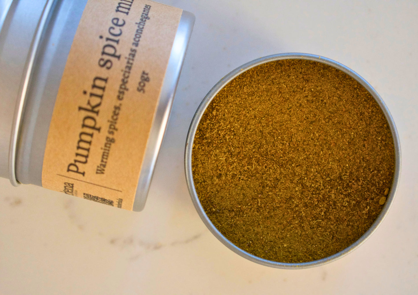 two aluminium tins with Pumpkin Spice Mix, one of them is open and we can see the powder mix