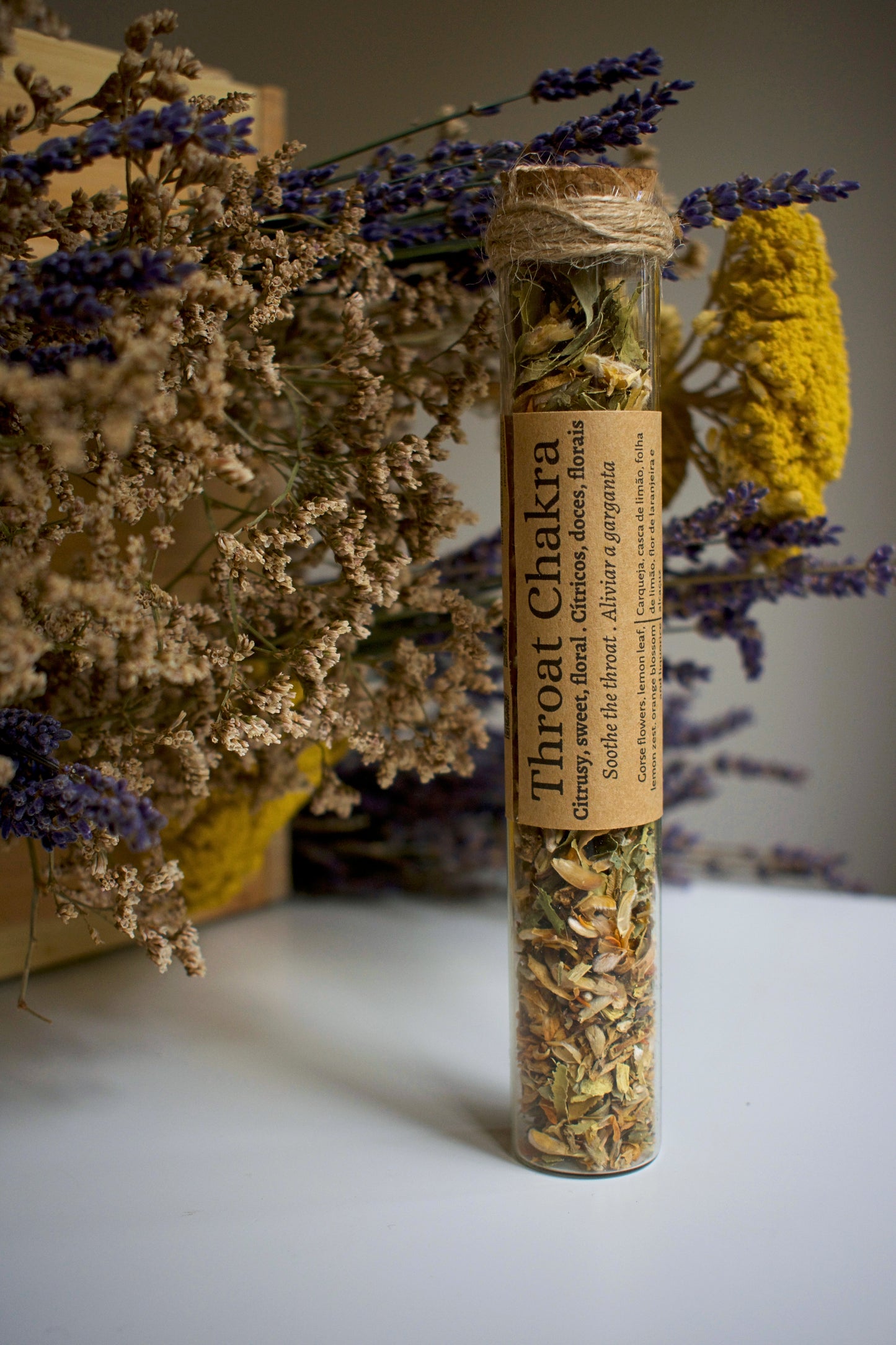 Glass tube with herbal blend Throat Chakra and label in kraft paper in the middle of the tube