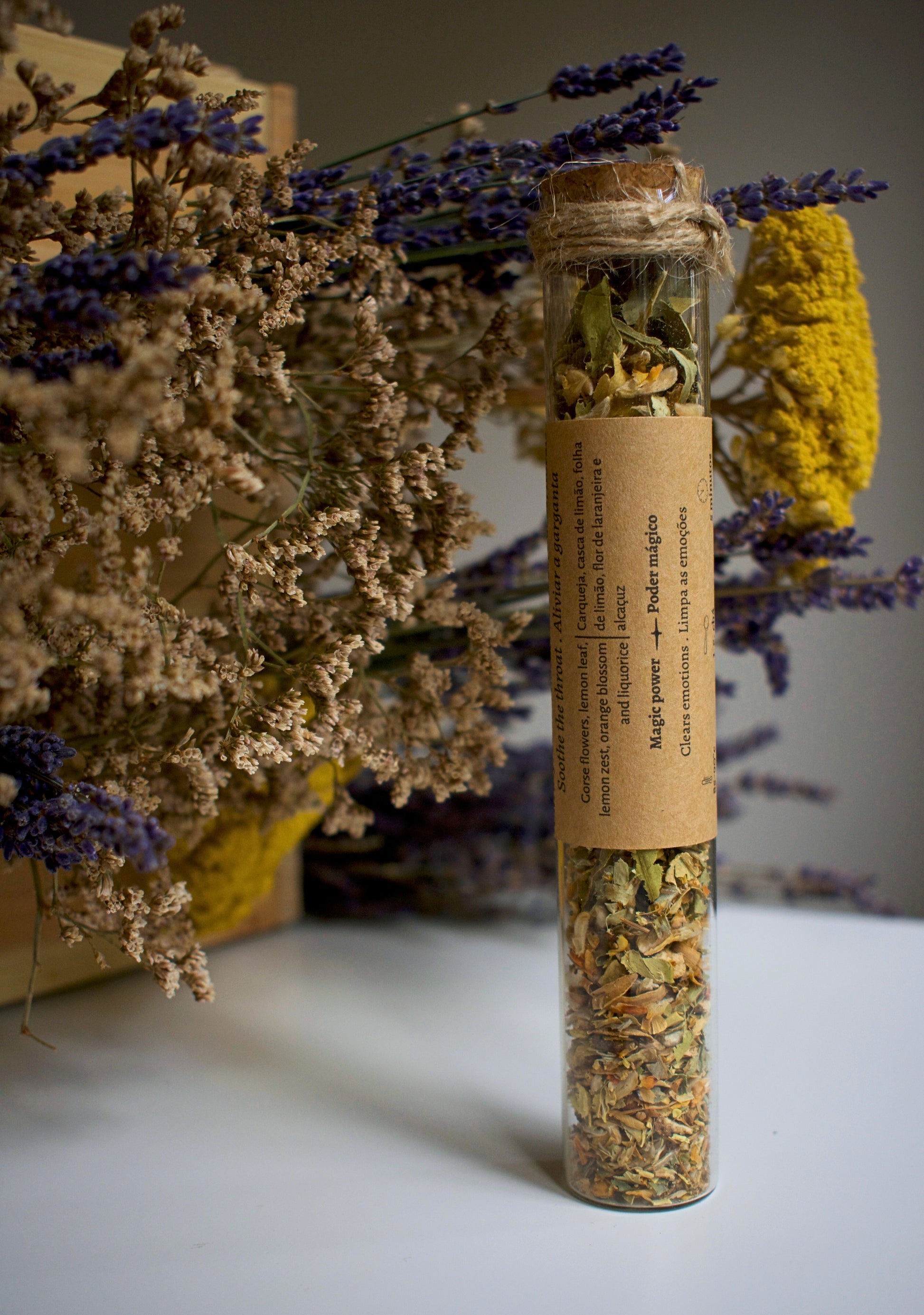 Glass tube with herbal blend Throat Chakra and label in kraft paper in the middle of the tube