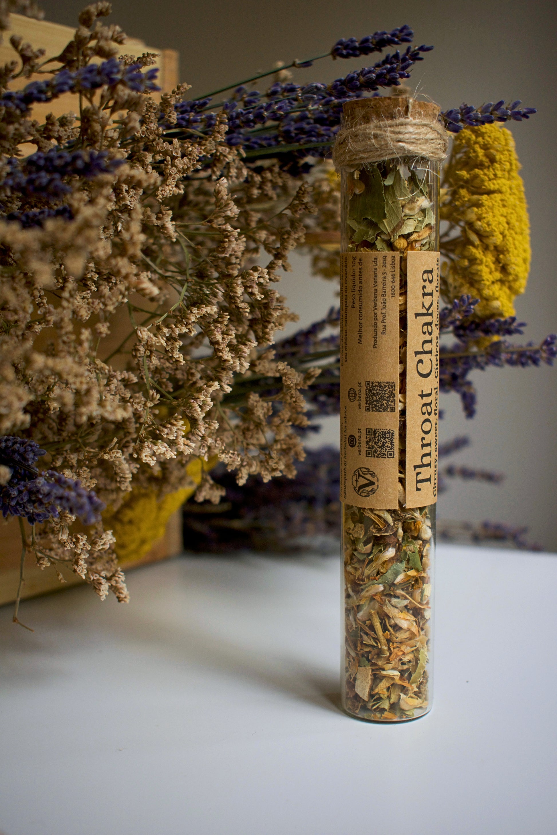 Glass tube with herbal blend Throat Chakra and label in kraft paper in the middle of the tube
