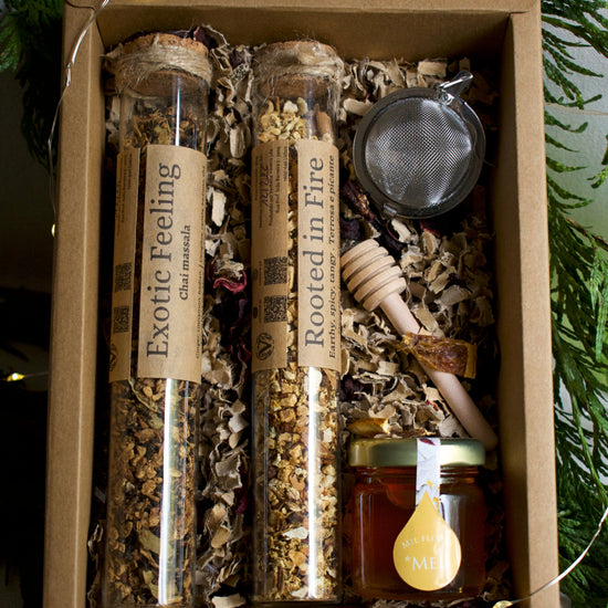 A drawer box, with tea set: 2 tea blends in glass tubes, 1 infuser, 1 honey wooden spoon and a little honey pot