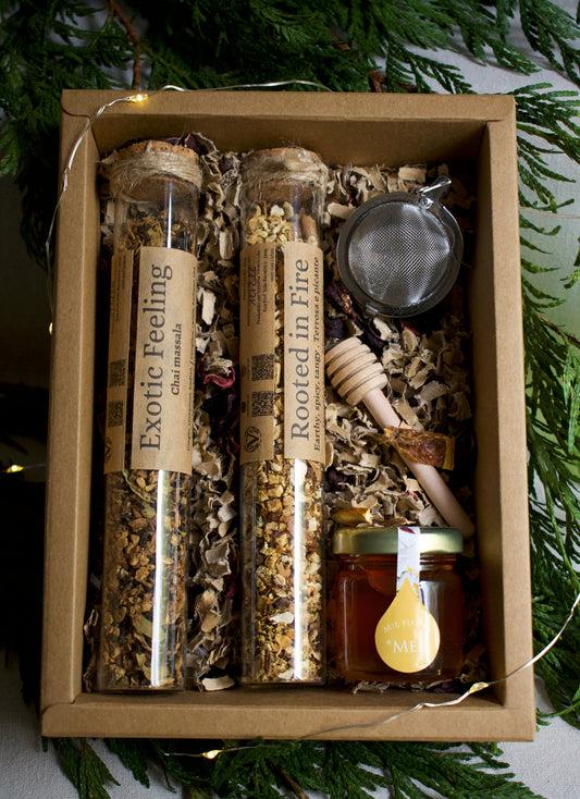 A drawer box, with tea set: 2 tea blends in glass tubes, 1 infuser, 1 honey wooden spoon and a little honey pot